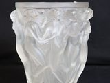 a glass vase with a design on it on a black background