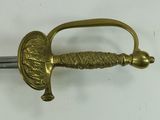 a close up of a sword on a white surface