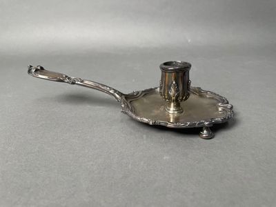 a silver plate with a spoon on it on a table