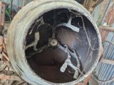 une bétonnière posée au milieu d'un tas de gravats