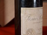 a bottle of wine sitting on a table with a box in the background