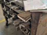 a workbench that has a lot of papers on it