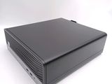 an image of a black computer sitting on top of a white surface
