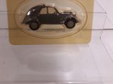 a small black car in a clear display case