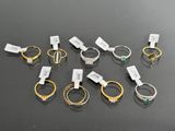 several different types of rings with tags on them on a table
