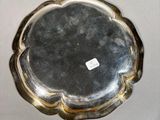 a silver plate on a table with a sticker on it