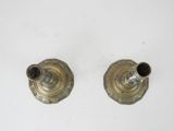 pair of antique brass candlesticks on a white background