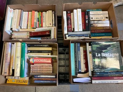 many books that are in a box on the floor