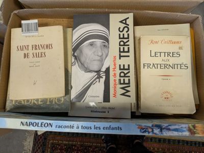 many books in a box on a table