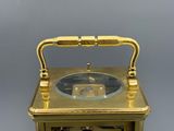 a gold clock that is sitting on top of a table