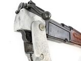 an old gun with a wooden handle on a white surface