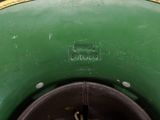 a close up view of a large green vase