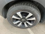 a close up of a tire on a car in a parking lot
