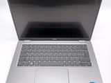an open laptop computer sitting on top of a white table
