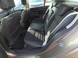 the back seats of a car with a black leather seat cover