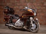 a brown motorcycle parked in front of a brick wall