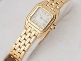an image of a gold wrist watch in a box on a white surface