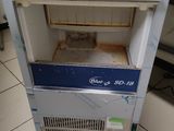 a small oven sitting on a cart in a kitchen