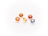 a group of three different colored gems on a white surface