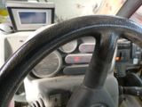 a steering wheel of a truck with a monitor in the background