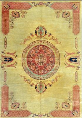 a yellow and red rug with a medallion design on it
