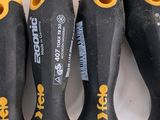 four different types of screwdrivers are lined up on a white surface