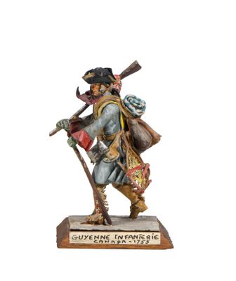 statue of a man with a rifle and a hat holding a bag