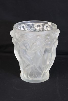 a glass vase with a design on it on a black background
