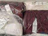 two bags of clothing sitting on top of each other