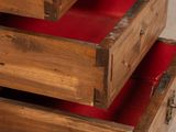 a wooden drawer with three red drawers on it