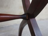 a close up view of a wooden table with a metal base