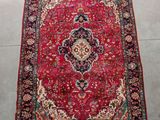a red rug with a medallion design on it