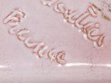 a close up of a pink soap bar on a table