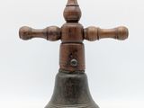 an old wooden bell with a wooden cross on top of it