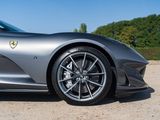 the front of a silver sports car parked in a parking lot