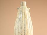 a white vase that is sitting on a table