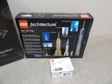 a box of lego architecture on the floor next to a box of legos