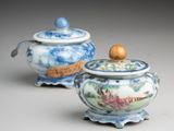 two small blue and white jars with lids and a wooden lid