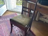 a chair that is sitting on a rug in front of a window