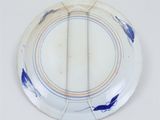 a white plate with a blue fish design on it