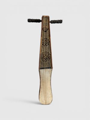a wooden stick with a design on it on a white surface