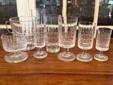 a lot of glasses sitting on a table next to each other
