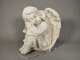 a statue of an angel sitting on a rock