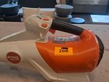 an orange and white electric blower sitting on top of a counter