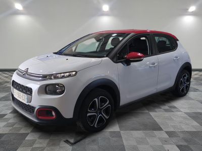 a white citrole is parked on a checkered floor