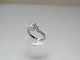 an image of a diamond ring on a clear ring holder