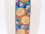 a vase with a colorful design on it on a white surface