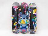 three skateboards with different designs on them on a white surface