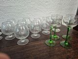 many wine glasses lined up on a wooden table