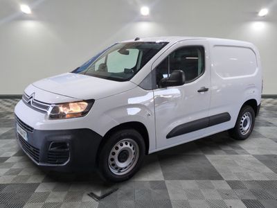 the white van is parked on a checkered tile floor